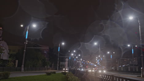 night view of a city street with illuminated building