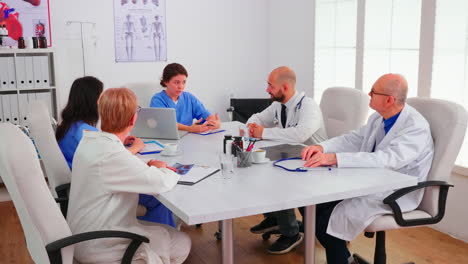 team of expert doctors having a briefing in hospital conference room