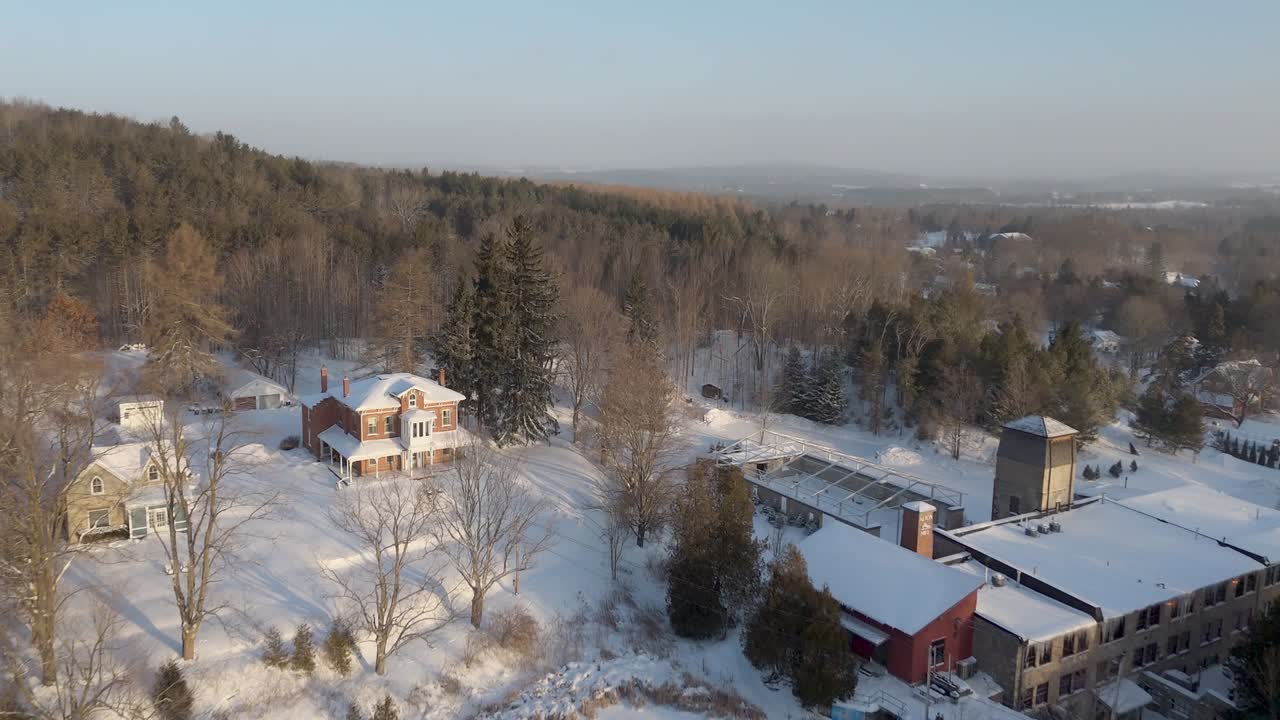 Aerial Flyover Of The Alton Mill And Pond Skating Rink At Sunrise In Caledon, Ontario, Canada.