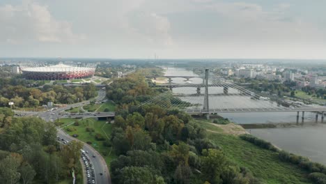 Panoramic-Aerial-view-of-Vistula-River,-Swietokrzyski-Bridge-and-The-PGE-Narodowy-National-Stadium-Warsaw,-Poland