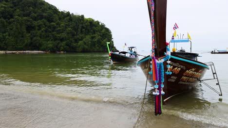 boat approaches shore in krabi, thailand