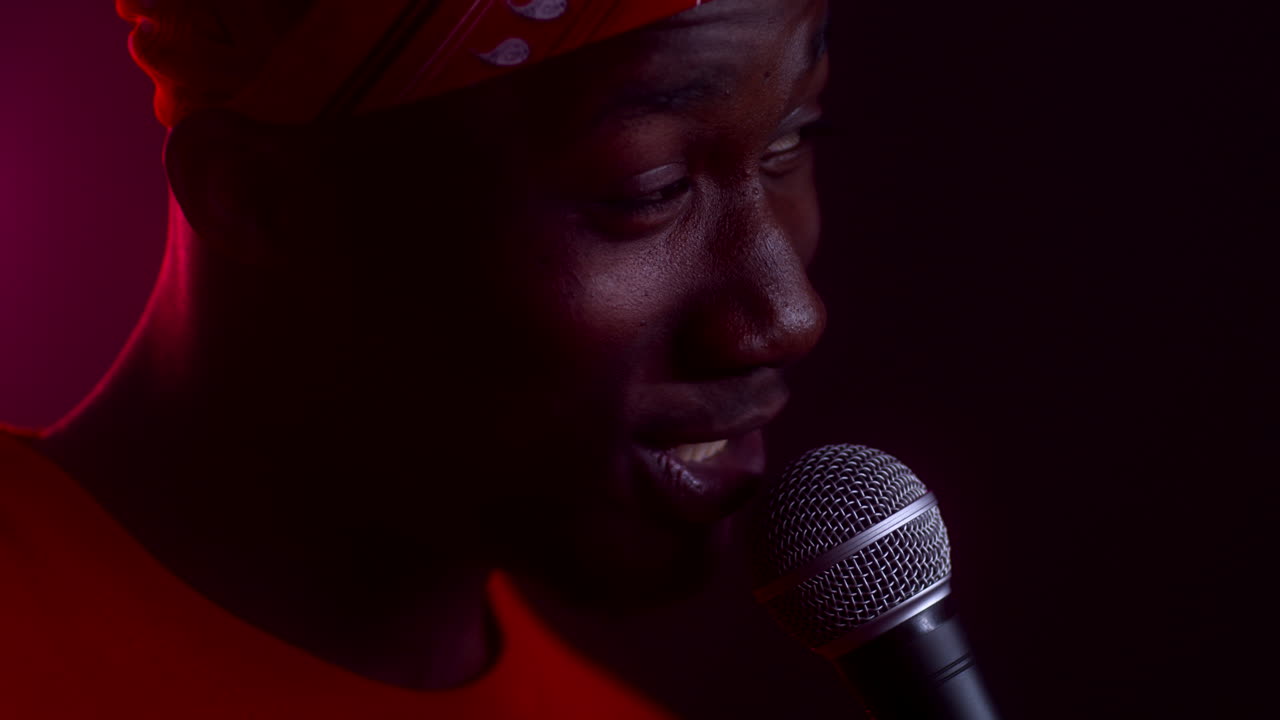 Man Singing Into Microphone on Stage