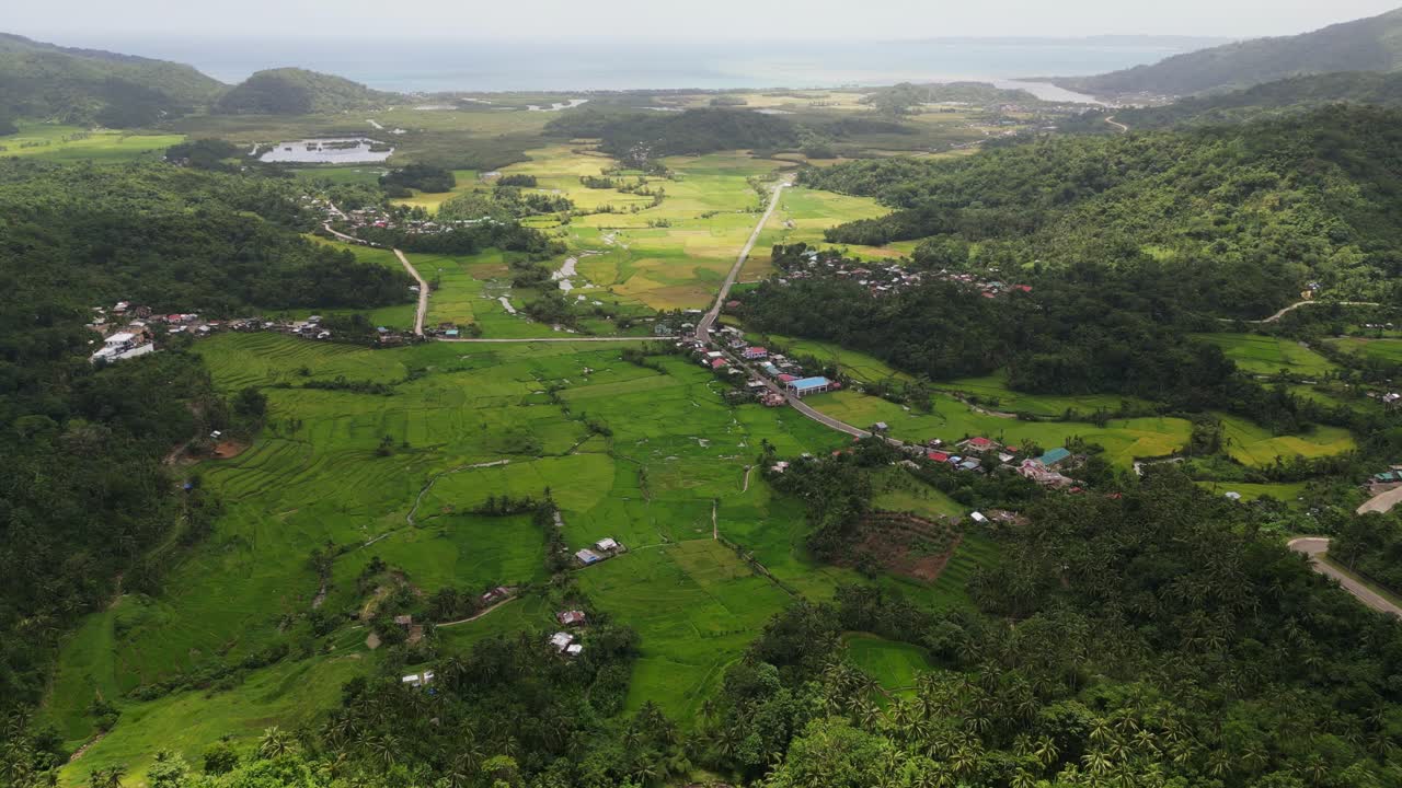 Panorama Of Libjo Village On A Hill Overlooking Rice Fields In Bato, Catanduanes Philippines. Aerial Drone Shot