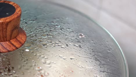 close up of a pot lid with condensation