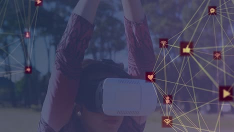 Globe-of-network-of-connections-against-girl-wearing-VR-headset-practicing-yoga