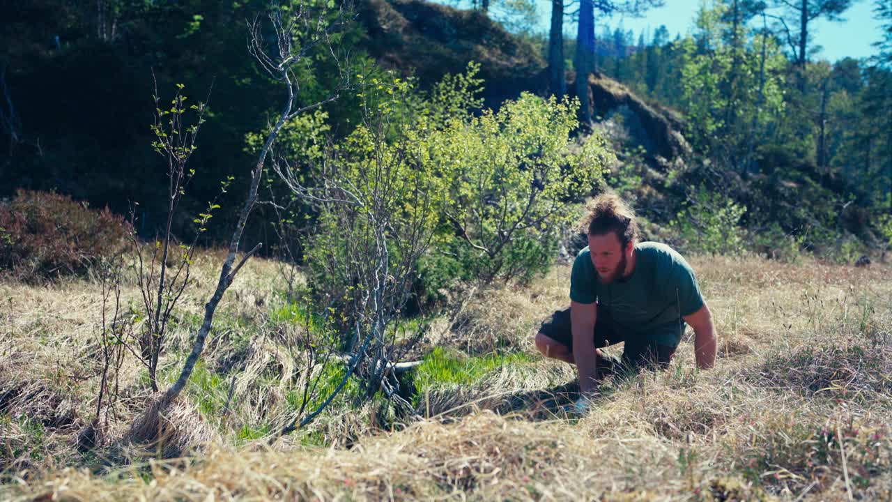 Man With Tumbler Gets Fresh Drinking Water From Ground