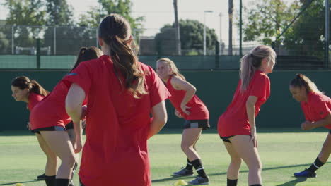 female soccer team warming up during training before match