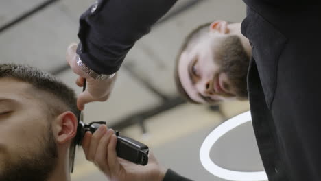 man getting a haircut at the barber shop