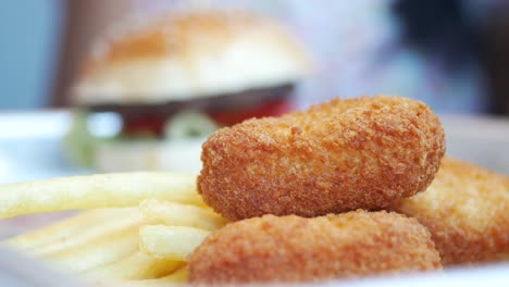 close-up of chicken nuggets, french fries, and a burger