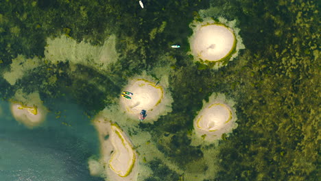 Top-view-of-small-sand-islands-in-the-bay-of-the-sea-at-sunny-summer-day