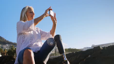 disabled woman clicking photo with mobile phone 4k