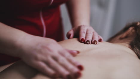 blonde-woman-undergoes-classical-massage-procedure-in-clinic