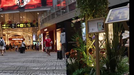 various people walking through a busy shopping mall