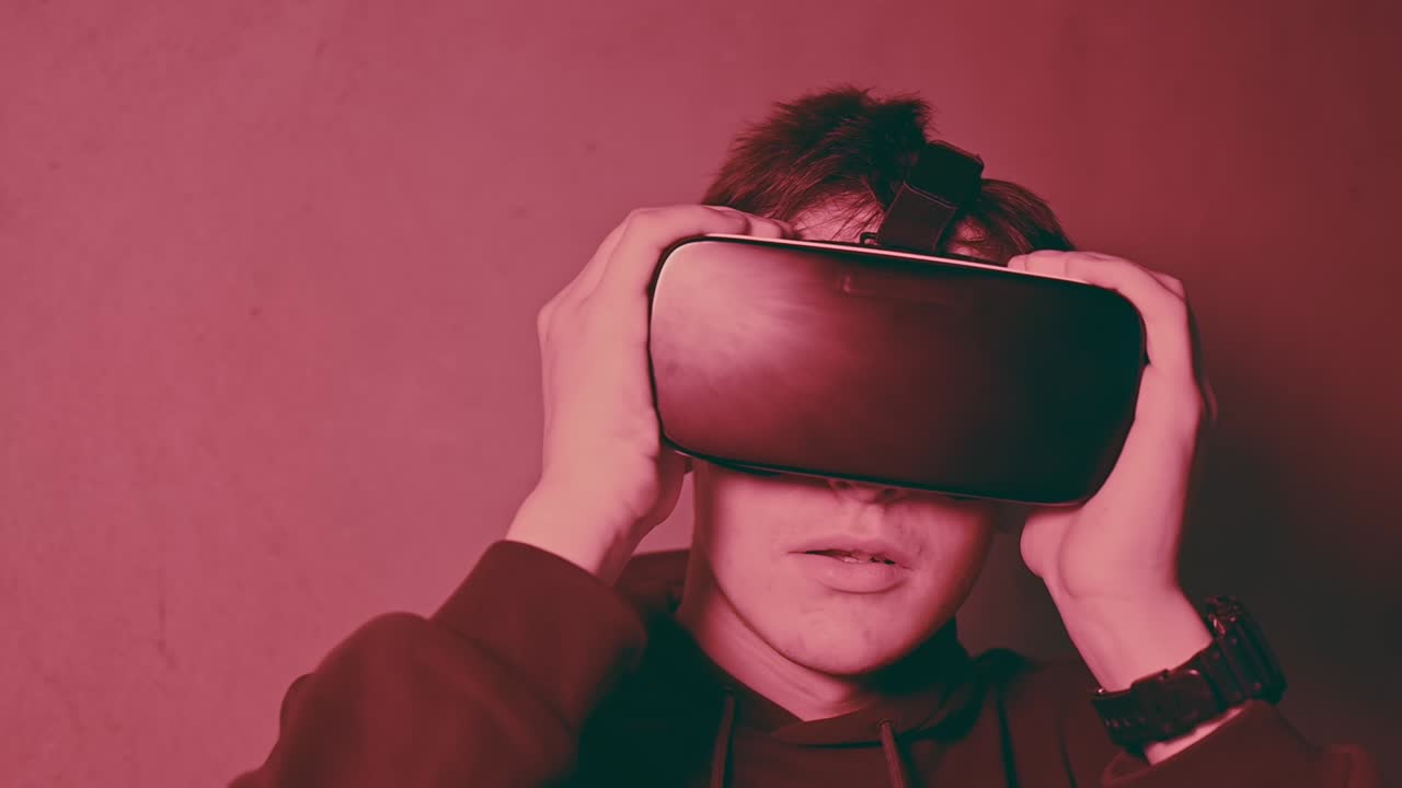 Young man amazed while wearing a virtual reality head set