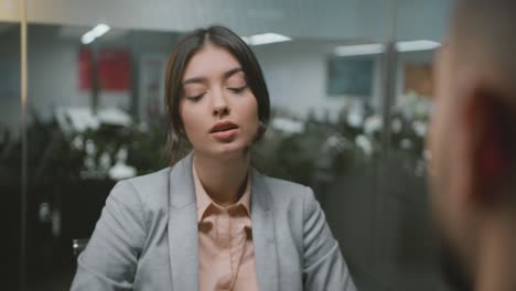 employment concept. young lady jobseeker wearing formal wear talking to entrepreneur, sitting at interview at office