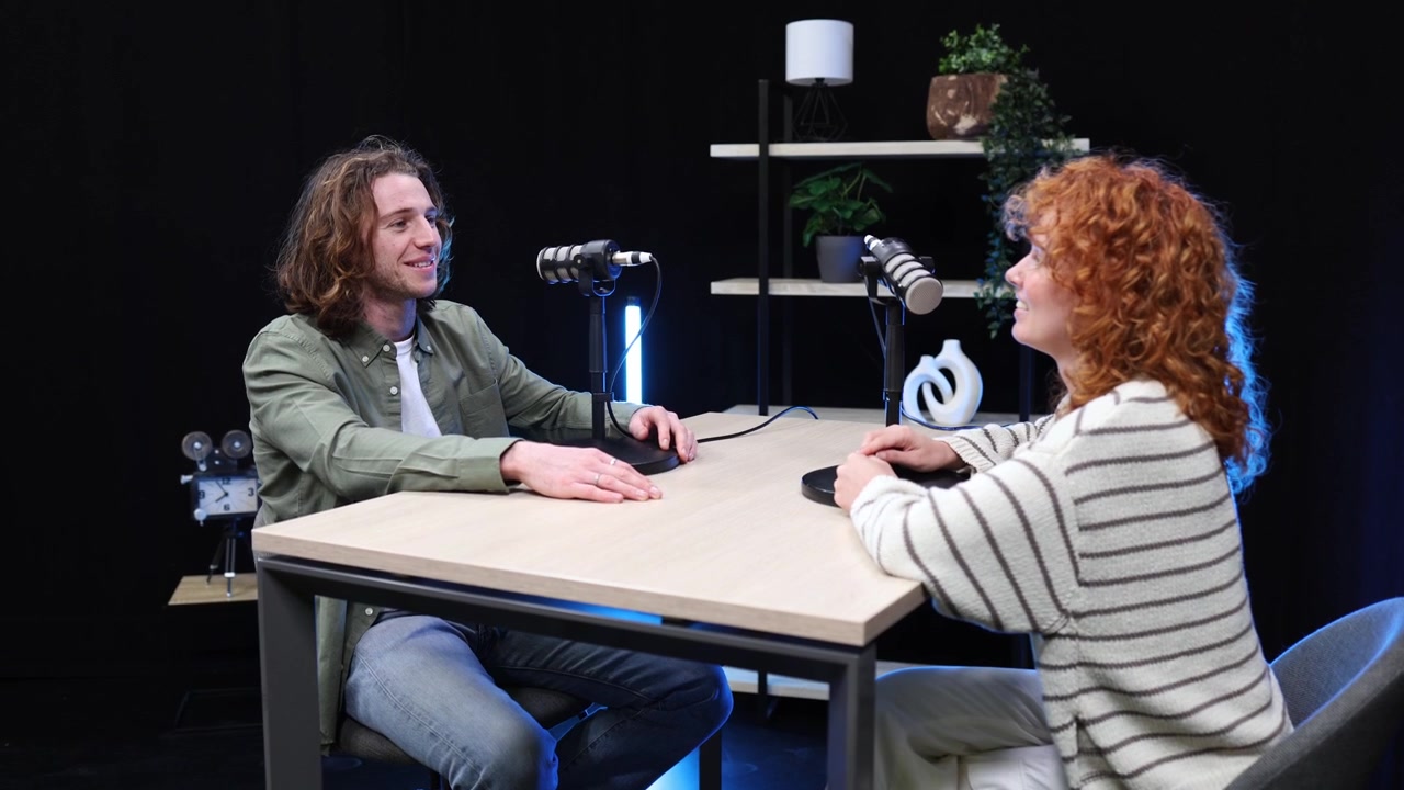 Man and Woman Recording a Podcast Interview in a Studio