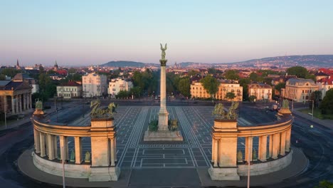 drone footage of the empty heroe's square in budapest, hungary at the time of the covid virus. early morning at the sunrise in spring.
drone flies slowly forward.
