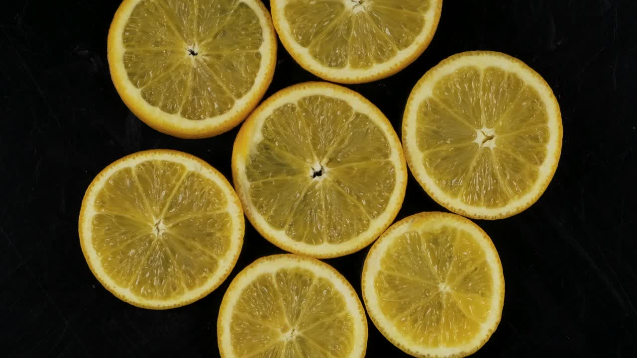 colección de rebanadas de naranja fresca en fondo negro. fruta cítrica de rotación. vista superior.