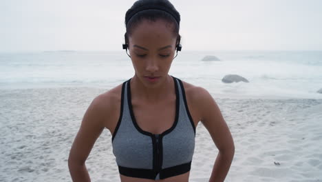 Woman-runner,-beach-and-face-with-headphones