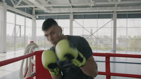 Man boxing in a gym ring