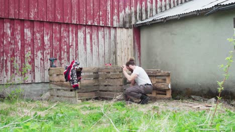 man assembling wooden pallets in the backyard. timelapse