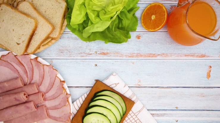 Making sandwich on the table full with food for breakfast and eating - stop motion