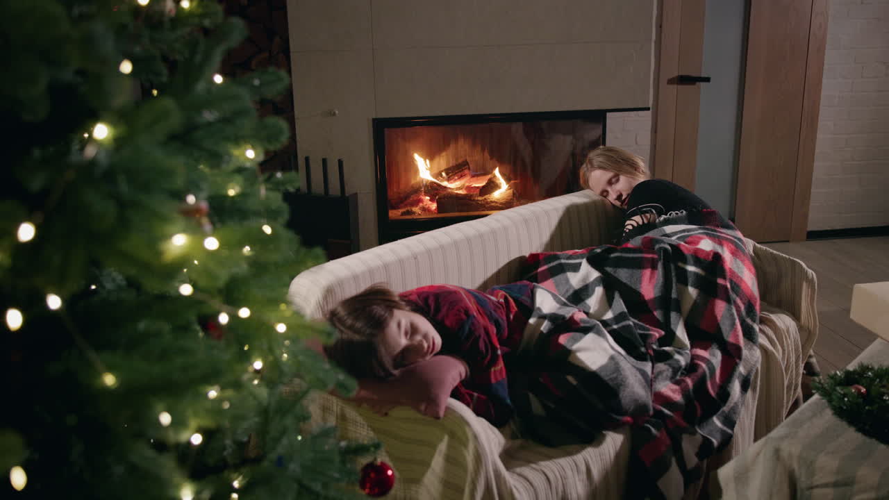 Cozy Christmas Scene with People Sleeping by the Fireplace