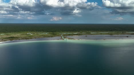 aerial view towards a catamaran in shallow, turquoise waters of lake bacalar lagoon, in sunny mexico