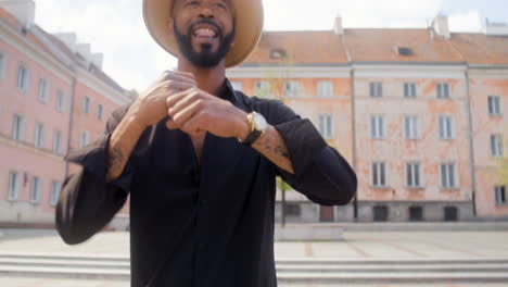 afro caribbean man dancing alone in a public square 5