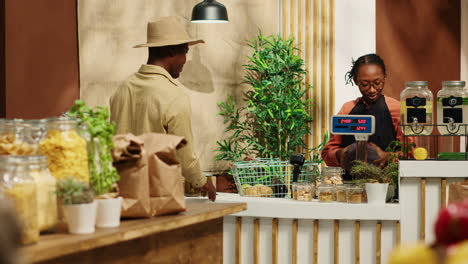 Woman-scanning-organic-goods-for-client-at-checkout-counter