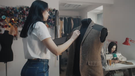tailor adjusting a jacket on a dress form
