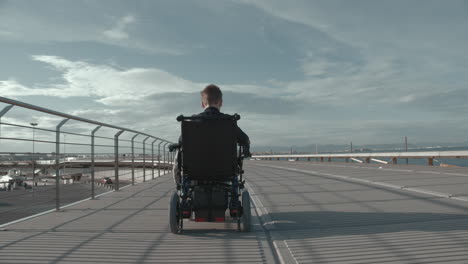 handicapped boy in electric wheelchair outdoor