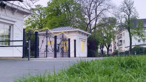 entrance to a park with black and gold noble gate