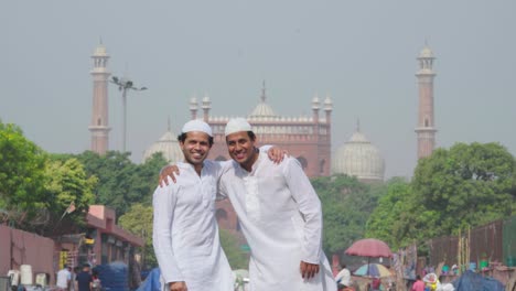 indian muslims greeting and hugging each other at a mosque