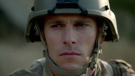 a close-up portrait of a serious soldier in military uniform and helmet