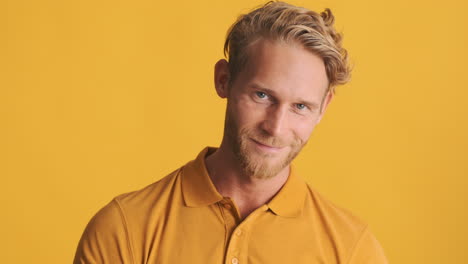 Guy-in-polo-T-shirt-saying-hi-with-his-hand-and-pointing-at-front