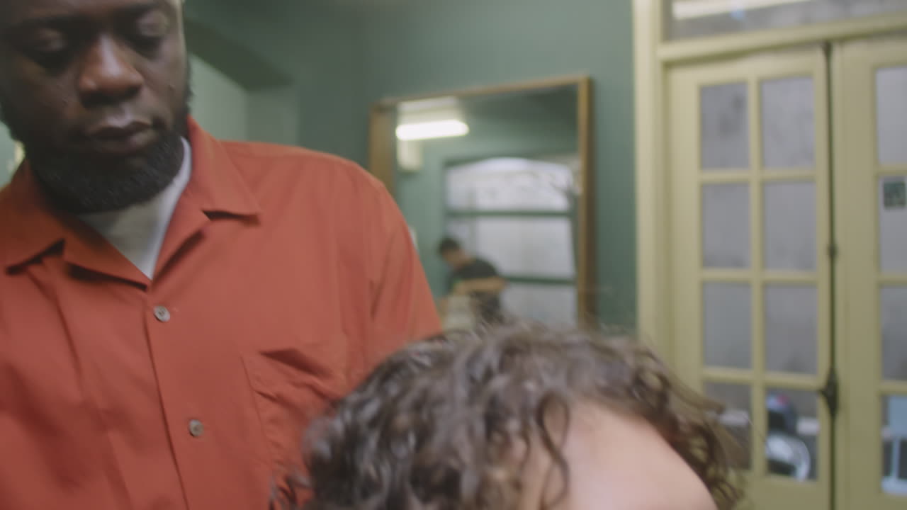 Barber Putting Hairdressing Cape on Customer