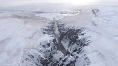 aerial view of fjaðrárgljúfur canyon in south iceland during winter - drone shot