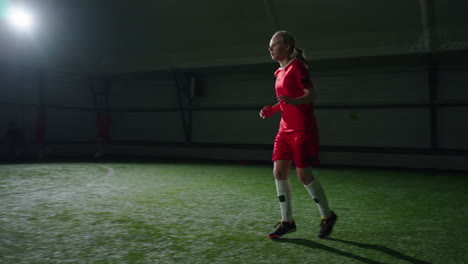 female soccer player practicing indoor