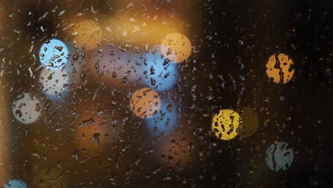 rainy night cityscape through a window