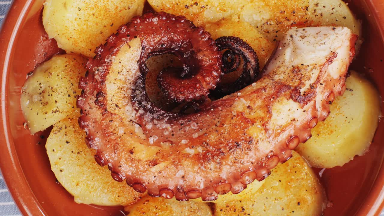 Octopus cooking, chef grill fresh octopus galician style on restaurant kitchen, healthy food, seafood cafe in spain, traditional asian japanese spanish and mediterranean dish.