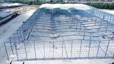 construction industry metal iron girder warehouse framework construction site aerial view slow dolly right shot