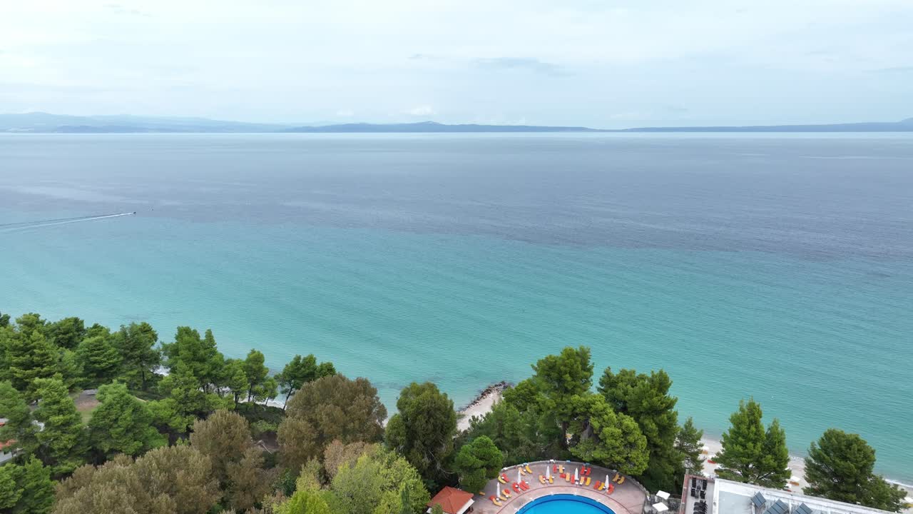Turquoise sea surrounding Alexander the Great Hotel in the Greek Peninsula of Chalkidiki. Aerial panoramic shot