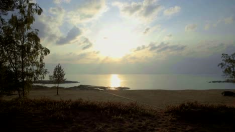 motion timelapse of clouds and sunbeams shining over horizon in scandinavia