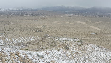 snow fall on the hills of joshua tree california