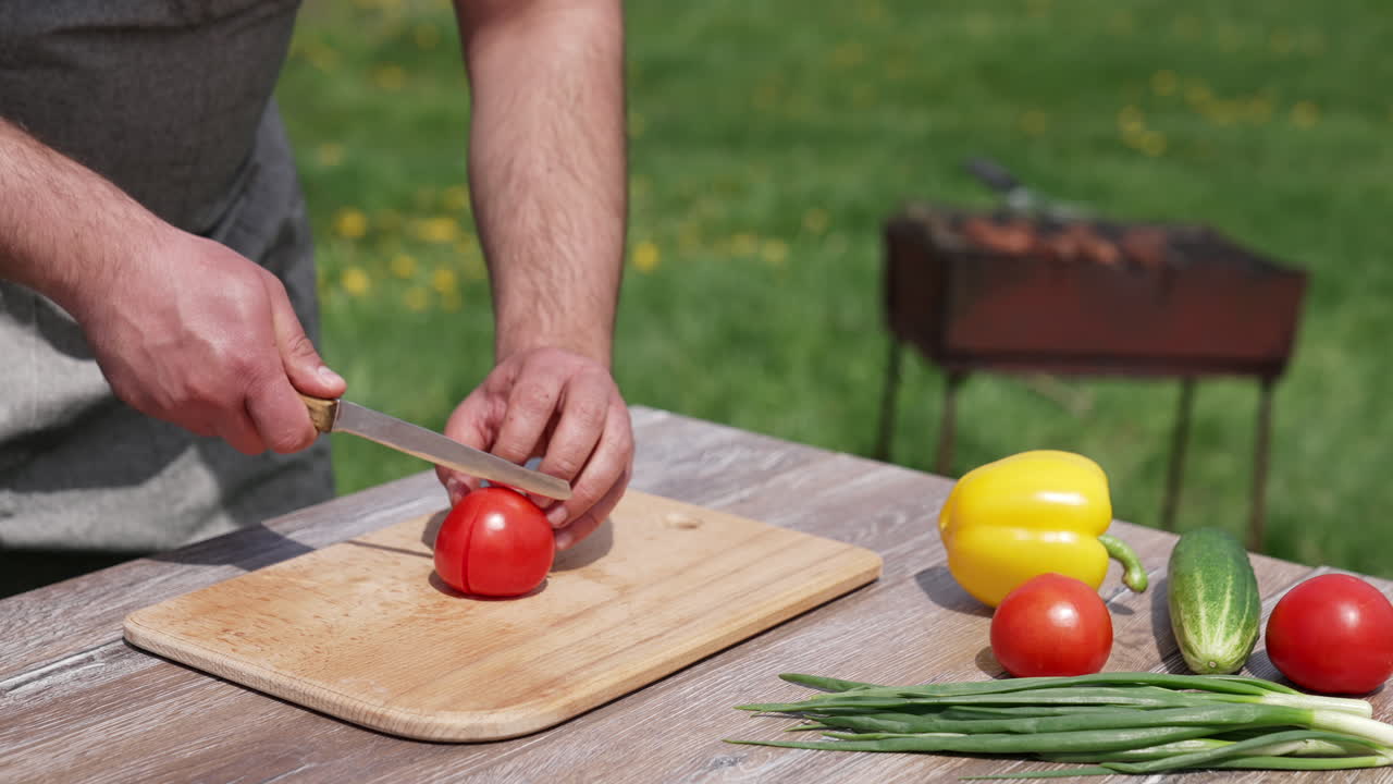 Human hands cutting ripe tomatoes. Organic slicing vegetables.