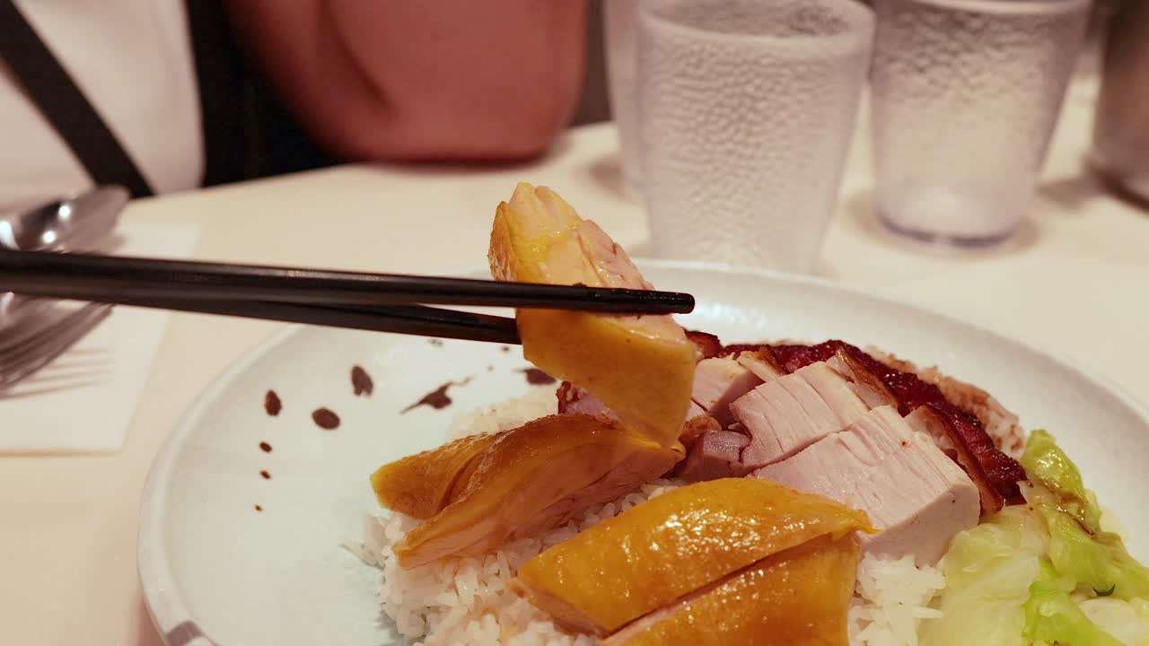 Chopsticks picking food from a delicious plate