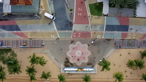 rising bird's eye top view of the center plaza at the touristic tambaú beach boardwalk in the tropical beach city of joao pessoa, paraiba, brazil with people gathering for pictures at the sign