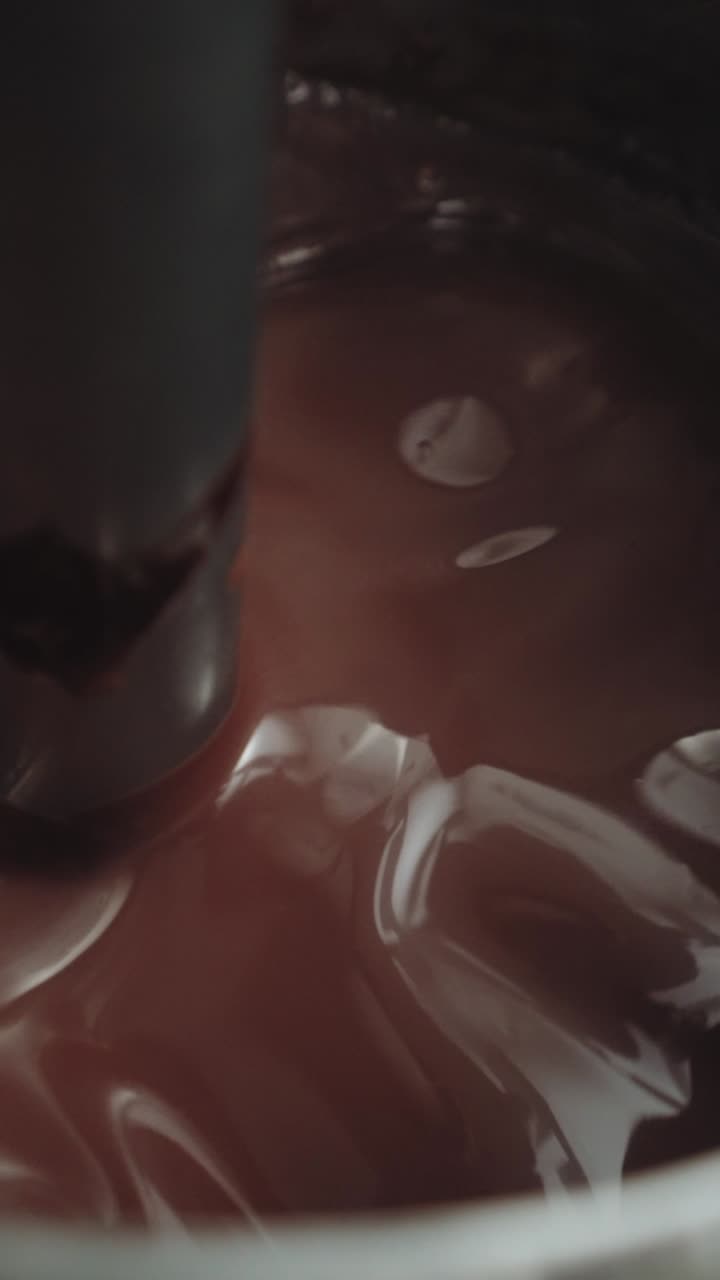 Stirring melted dark chocolate – professional macro food video