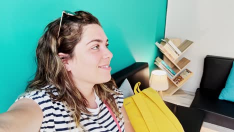 happy young woman smiling directly at the camera indoors